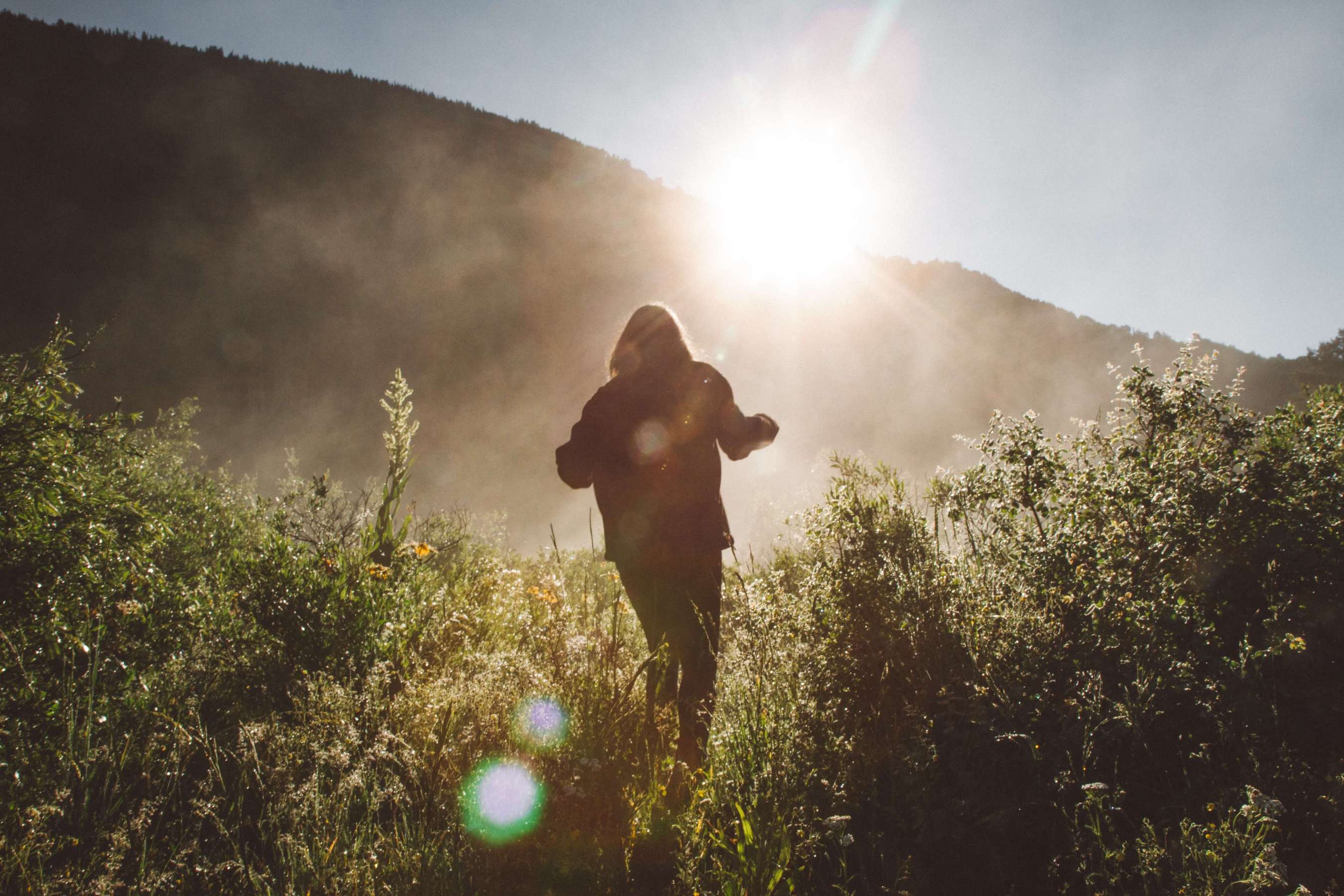 person walking through field